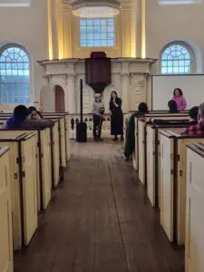 Man holding hobby horse standing next to a woman holding a microphone