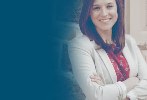 Portrait of smiling person with straight hair wearing red top with white blazer