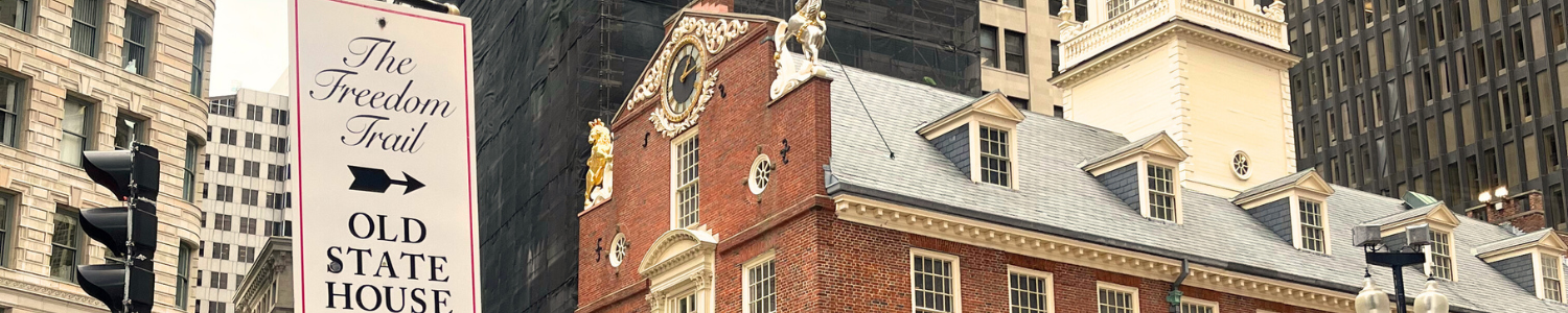 A street sign for The Freedom Trail next to the Old State House in Boston. Suitable for a private walking tour Boston.