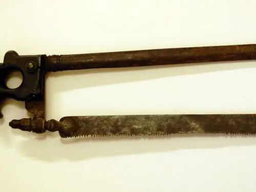 An old, rusty hacksaw with a pistol grip handle.