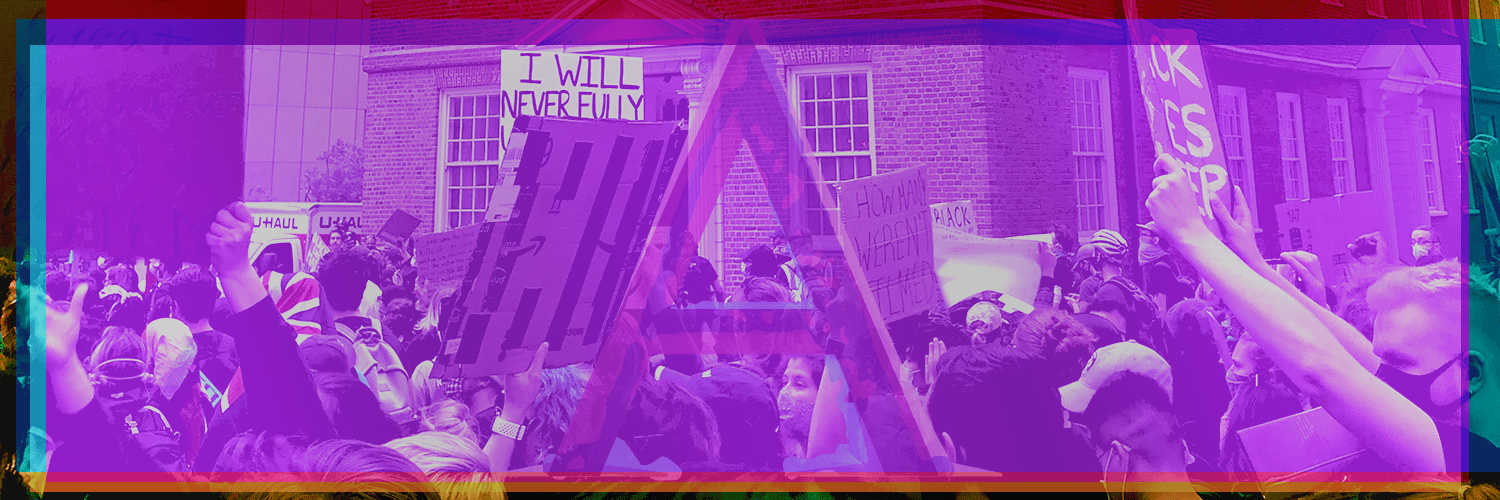 A purple-filtered protest with people holding signs.