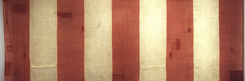 Wide flag with vertical red and ivory stripes of equal width
